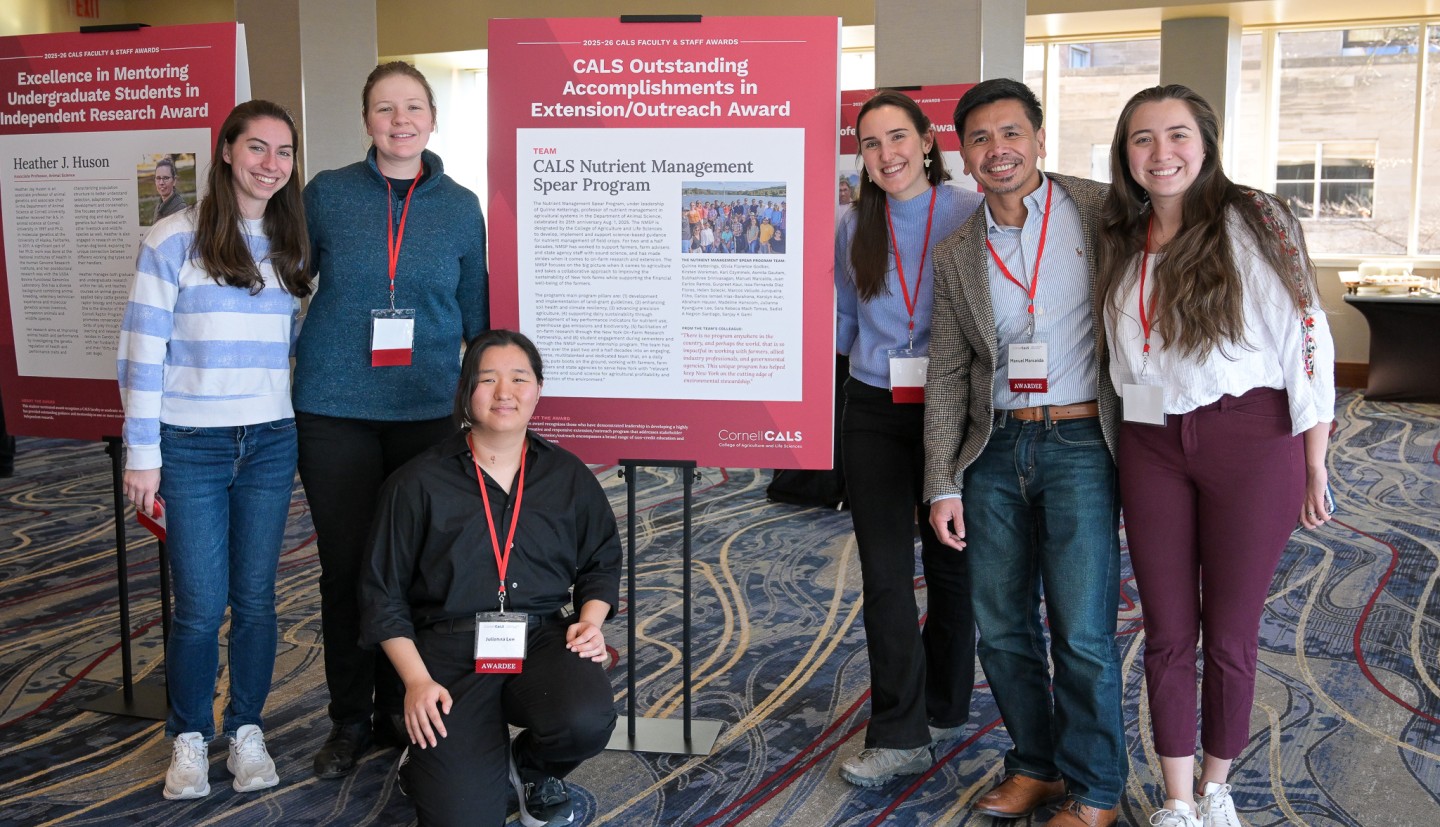 Team poses with a poster at the Faculty and Staff Awards ceremony