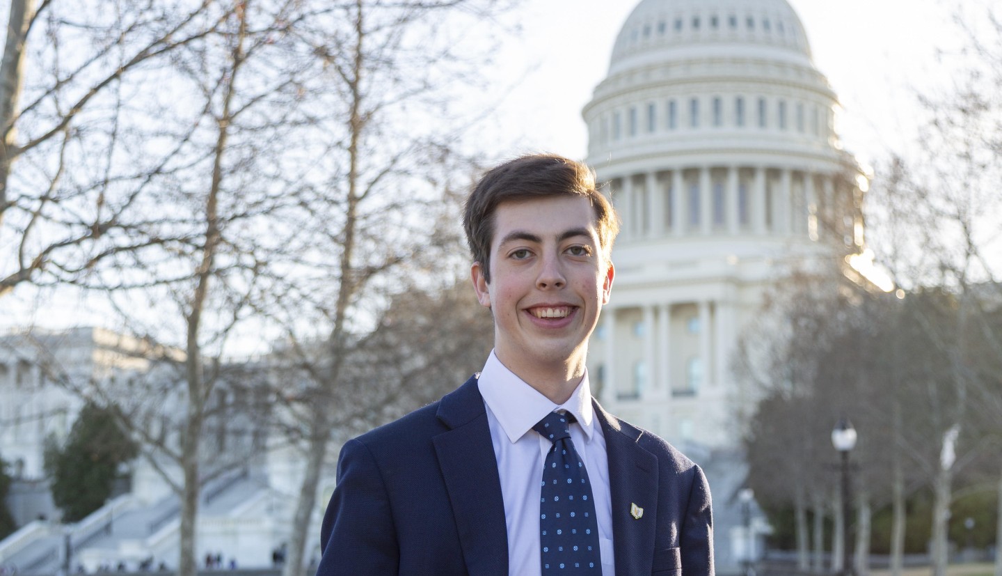 Dalton Mullins stands in front of monument