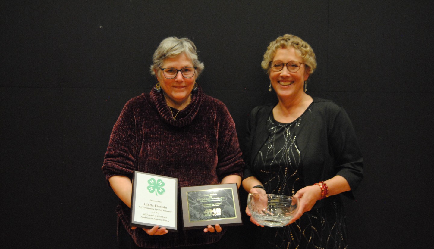 Elcsisin with Stepahine Graf (?) holding her 4-H National  outstanding lifetime volunteer awardaward