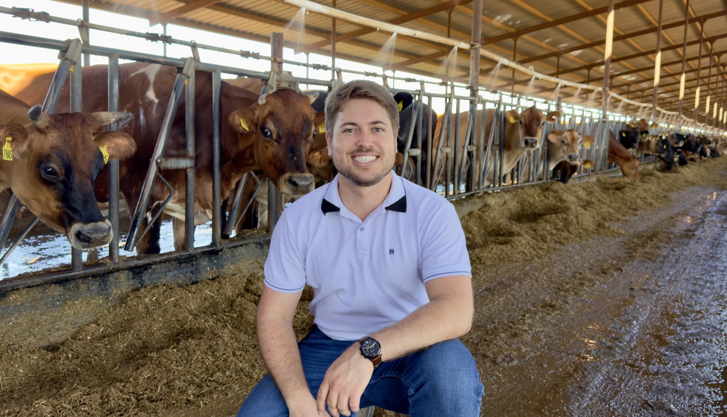 Hugo Monteiro standing in a barn in front of cows