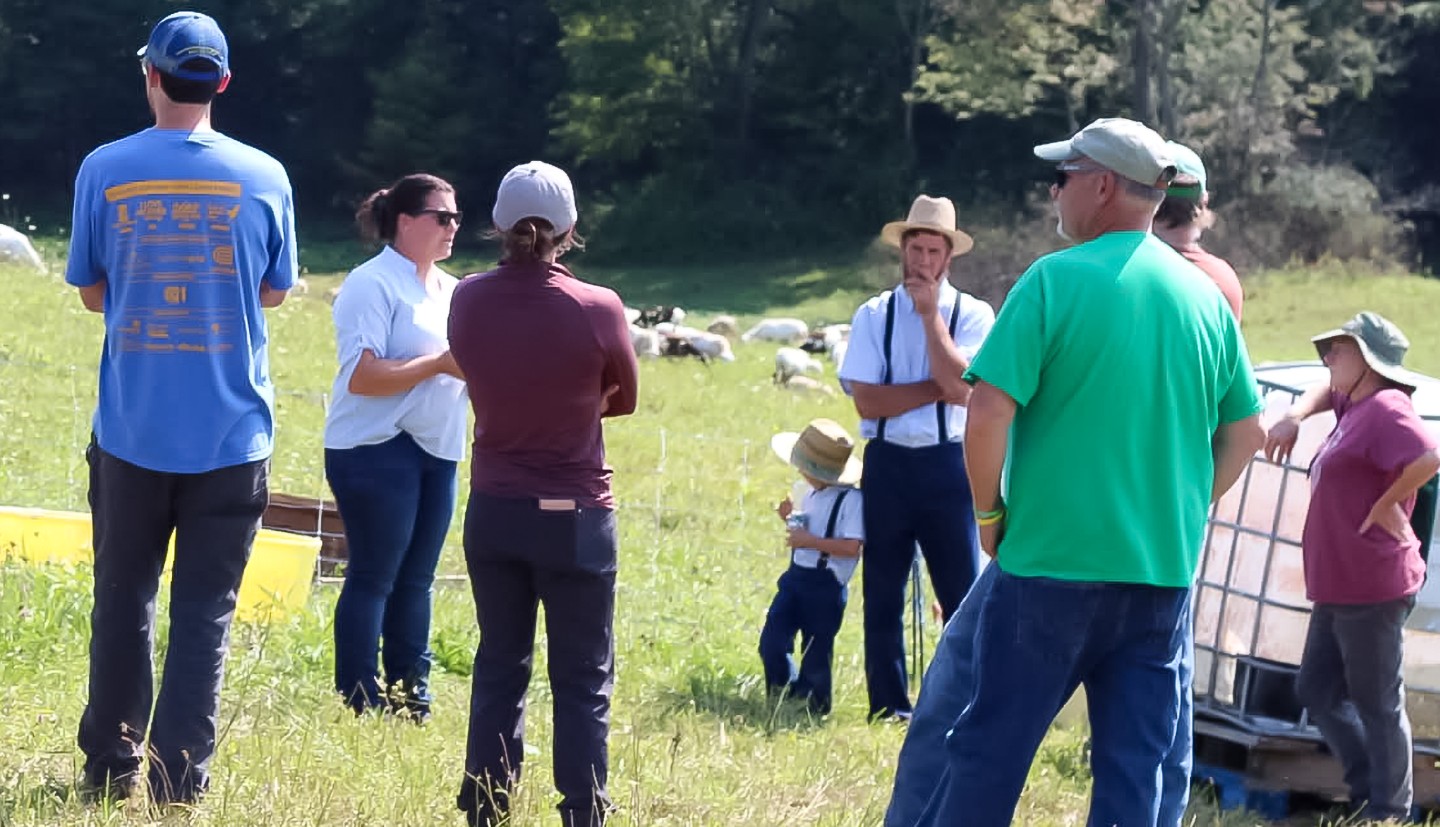 a group of people stand in a field