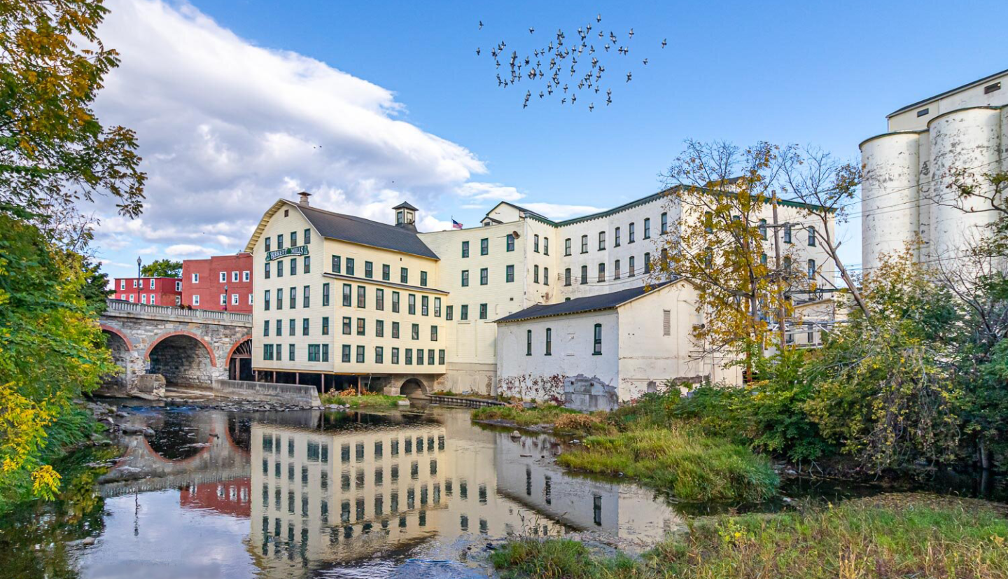 A historic building reflects in the water