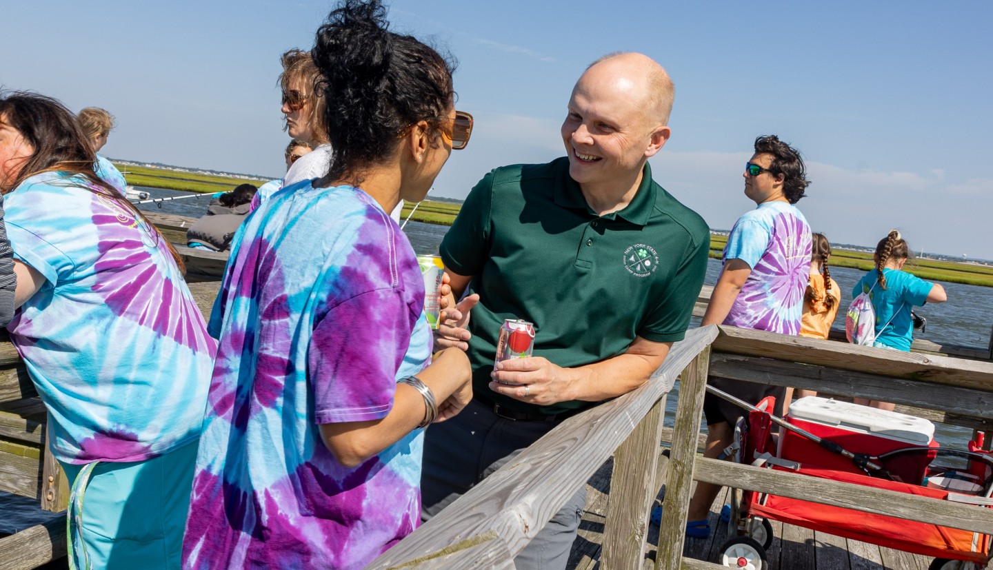 Shawn talking with  a participant at a 4-H outdoor  event