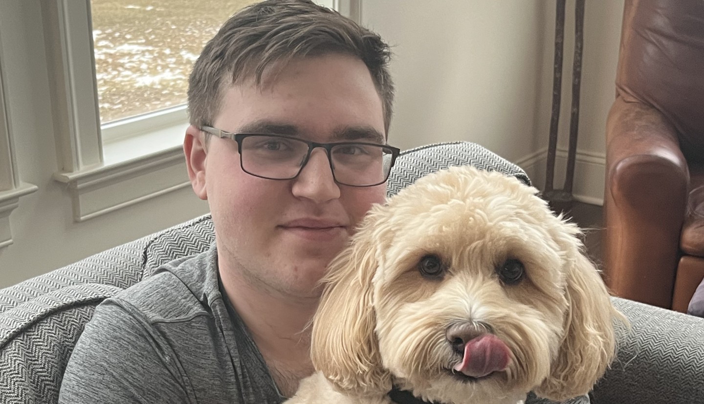 Person sitting with a dog on his lap