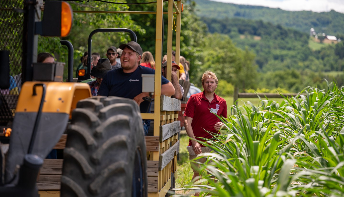 Erik Smith - walking beside tractor in cornfield at field day