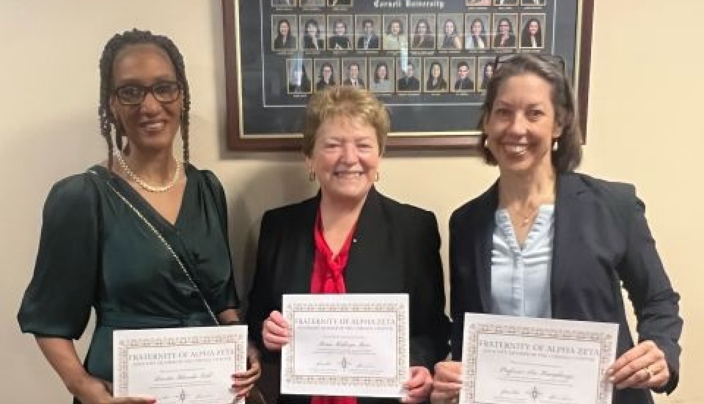 Three women holding certificates.