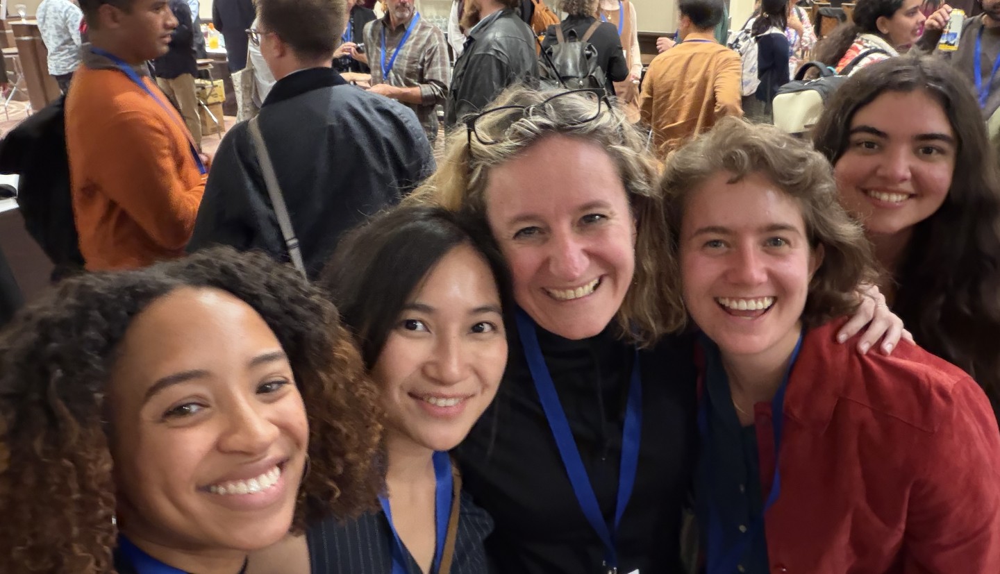 A selfie of four women at a conference