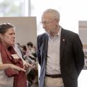 Kelly Zamudio and Provost Michael Kotlikoff talk in front of images on easels