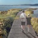 rendering of people walking on a path on a breaker