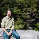 Pete McIntyre sitting on a stone bridge at Beebee Lake