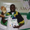Calvin Edward Gwabara holds a trophy