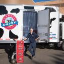 Chris Bush stands in front of a Cornell Dairy truck