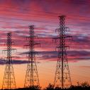 Power lines with a sunset behind them