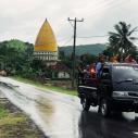 Group rides in the bed of a pick up truck in rural Indonesia