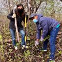 Two individuals volunteer at a wildlife refuge