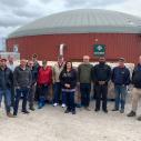 Group standing in front of an anaerobic digester at a Western NY dairy farm