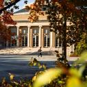 Student walks in front of campus building
