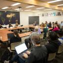 Classroom with students gathered around a roundtable.