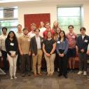 Animal science interns standing in the poster session presentation room