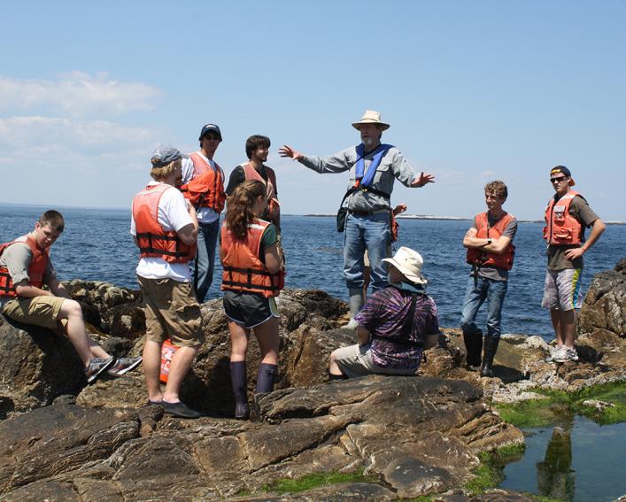 Jan Factor talks to student overlooking the ocean