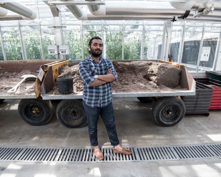 Vipul stands in front of a vehicle