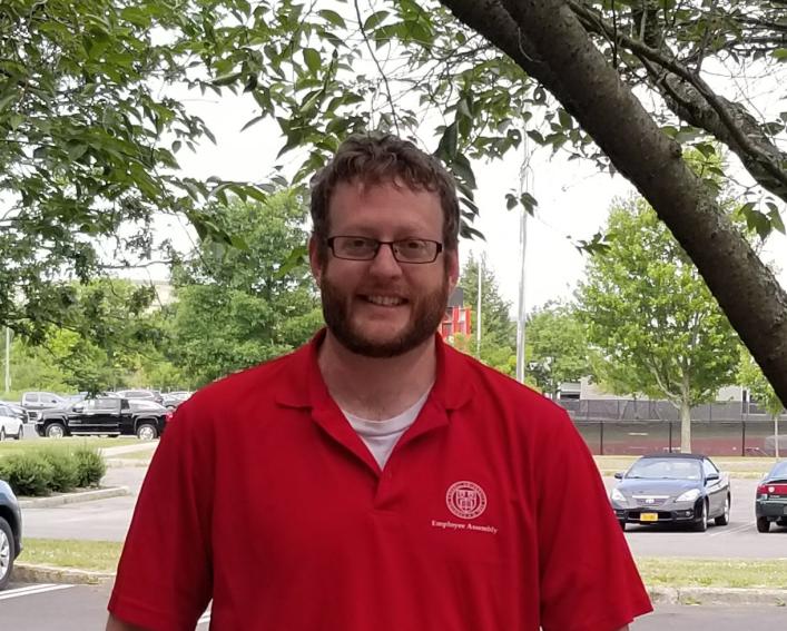 Adam Howell wearing a red Cornell shirt. 