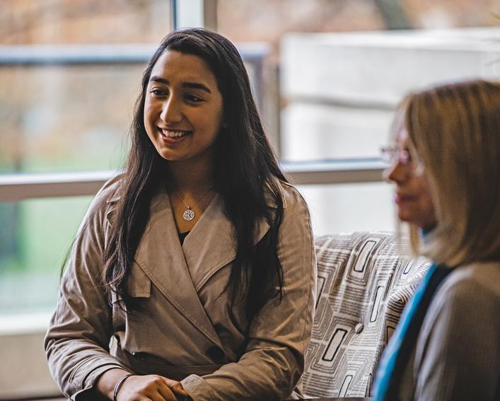 Two female alumni discuss their major at CALS in the Statler Hotel Lounge