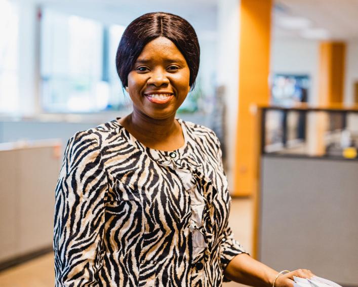 Woman smiling near bookcase 