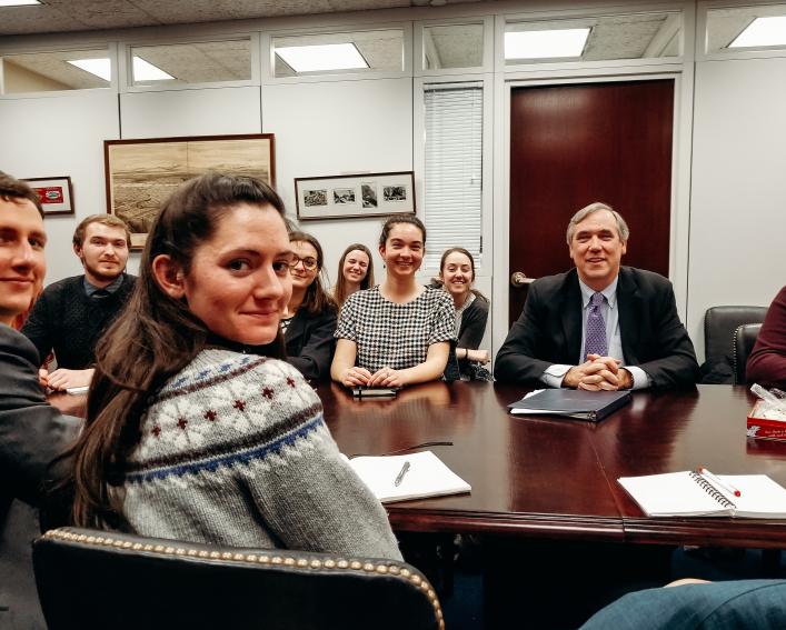 A group of students in a conference room with Oregon Senator Jeff Merkley.