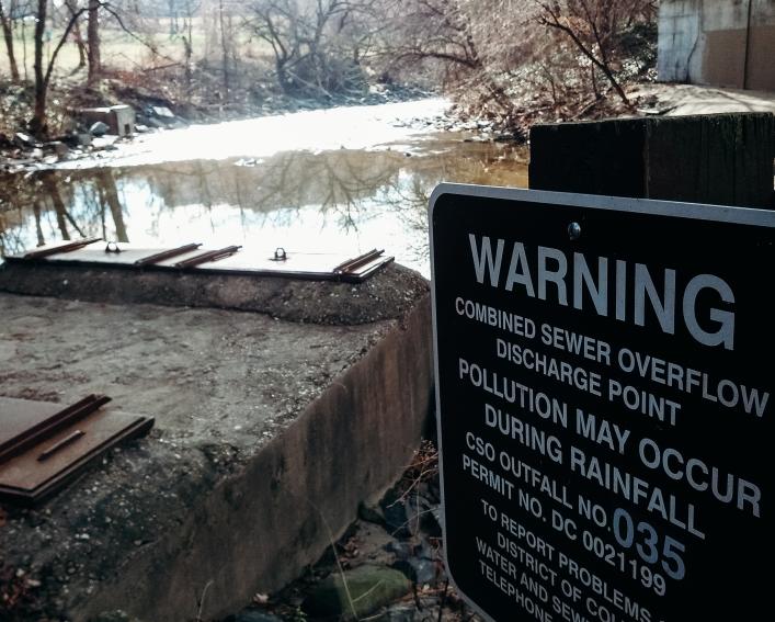 Warning sign near sewer overflow area in Washington DC