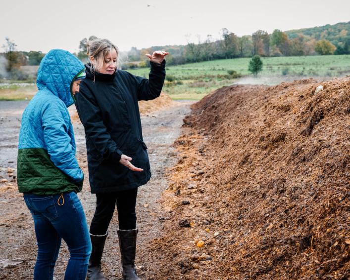 Professor instructing student about compost