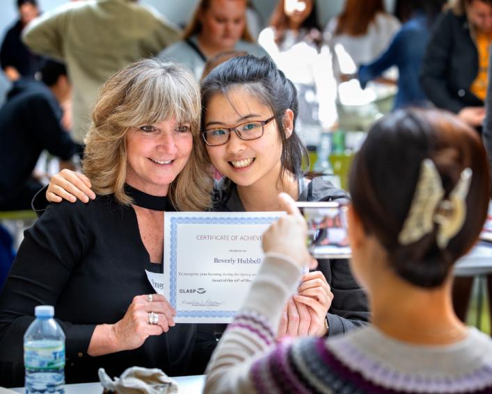 Two women holding a certificate at a CLASP event