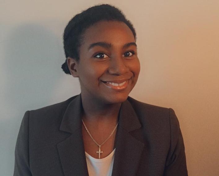 A college-aged woman smiles for a headshot