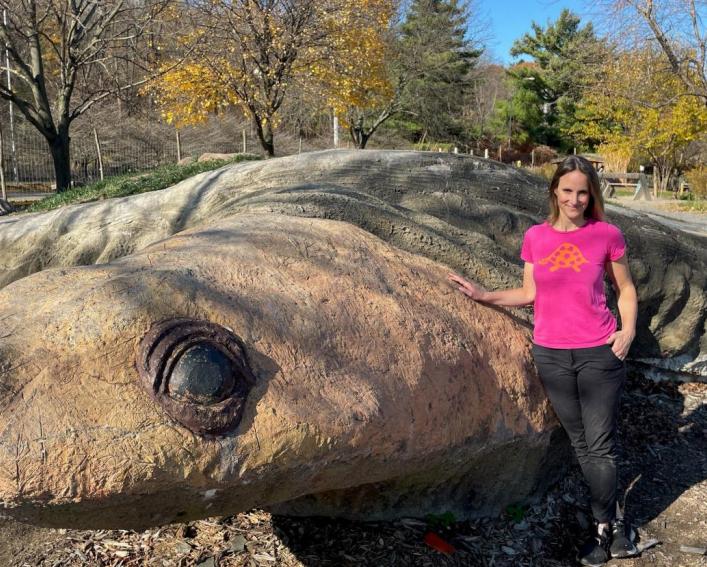 Erin Marteal by turtle island sculpture at Ithaca Childrens Garden