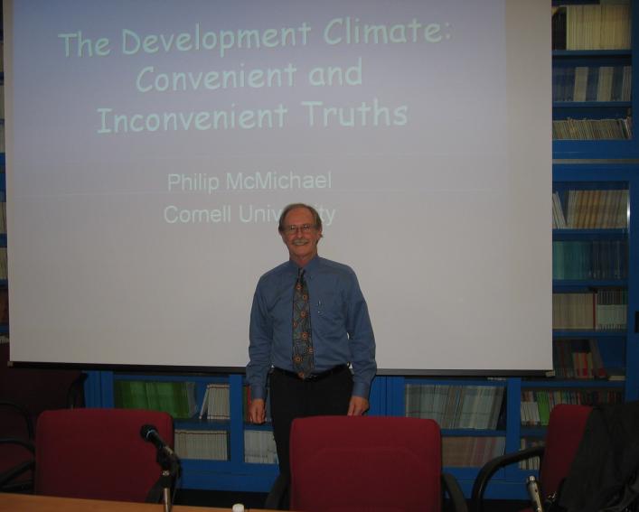 Philip McMichael stands in front of presentation screen