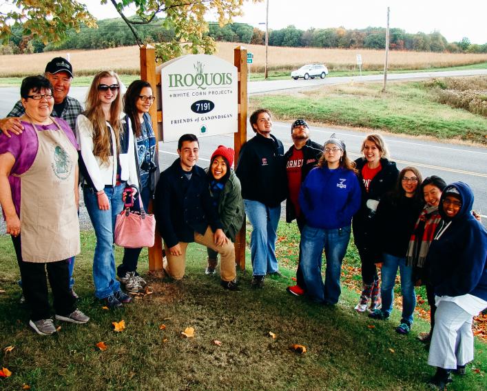 Akwe:kon students pose in front of Ganondagan State Historic Site sign.