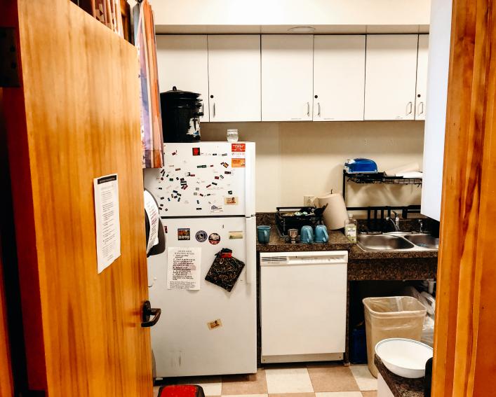 Akwe:kon kitchen includes a refrigerator, dishwasher, sink and cabinet space.