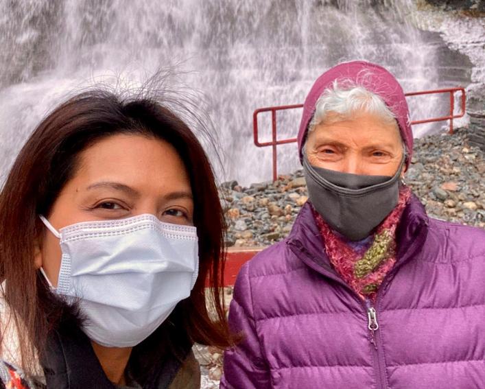 Selfie of two women in front of waterfall