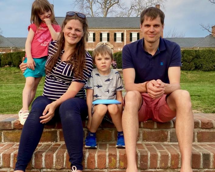 Family of four sits on steps
