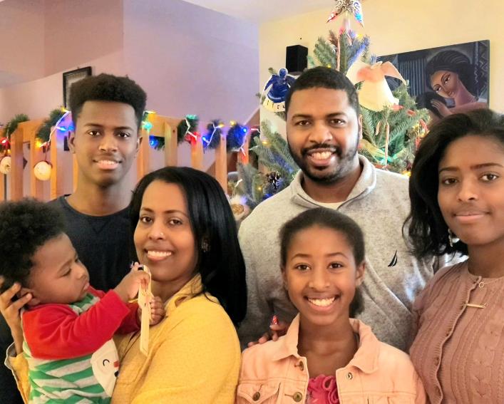 Family of six poses for a photo