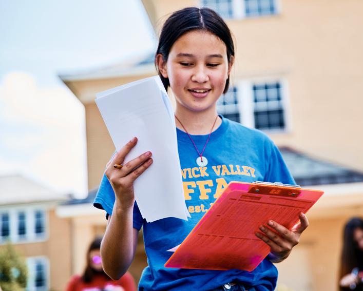 young female ffa member with clipboard