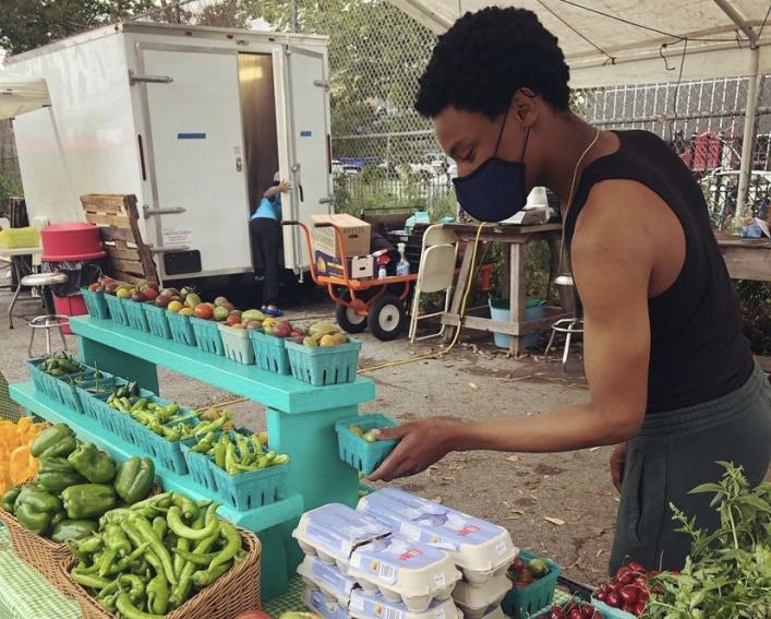 William Henderson working at a farmers market