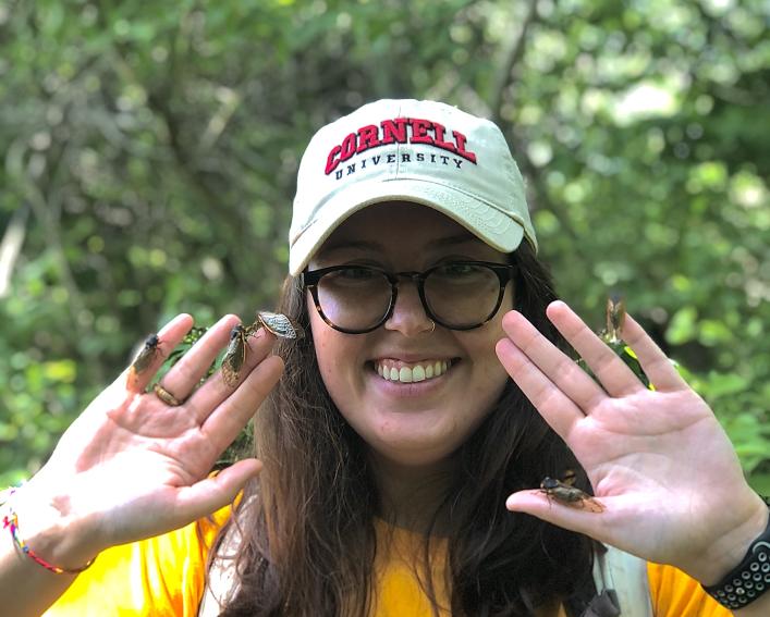 Woman poses with bogs on fingers.