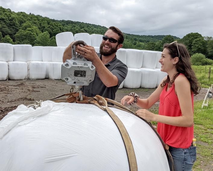 mikala with a plastic wrapped baleage