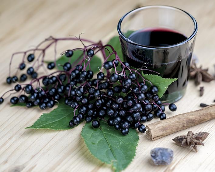 Elderberries and a glass of elderberry juice