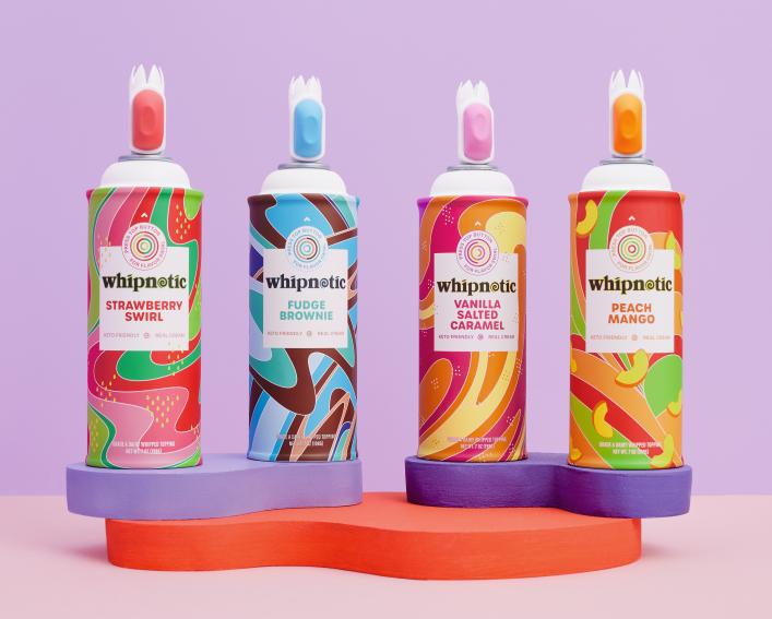 Four cans of Whipnotic whipped cream in a row.