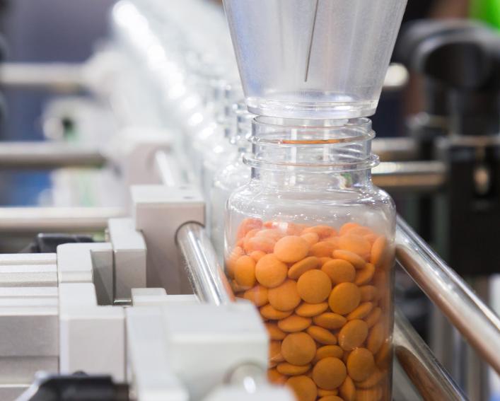 Pills being dispensed in packing line