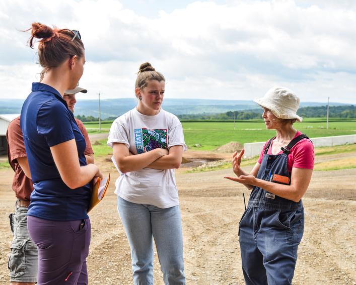 students talking with farmer