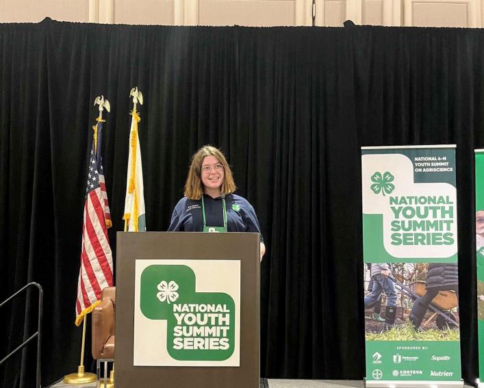Woman speaks at conference podium