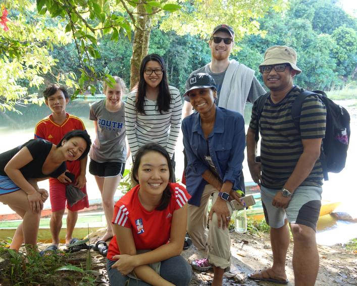 Group poses for a photo while hiking